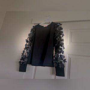 size small in women's black shirt with black flowers